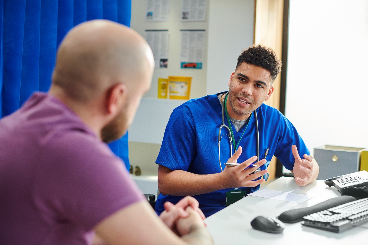 A person talking to a person Description automatically generated